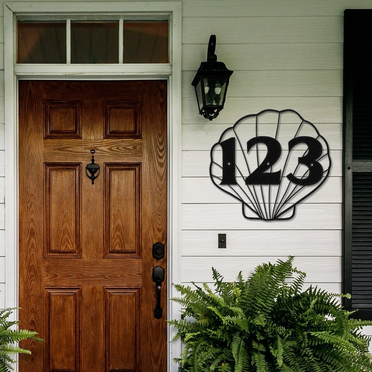 Unique House Number Signs - Shell shaped house number sign on the wall of a front door