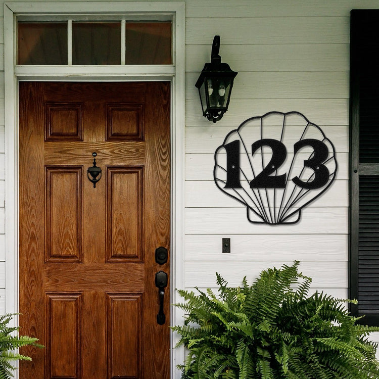 Unique House Number Signs - Shell shaped house number sign on the wall of a front door