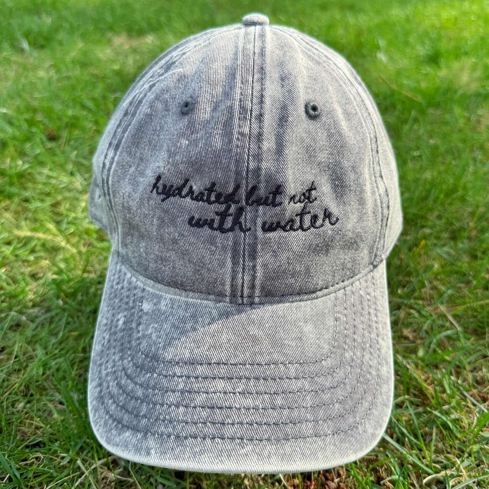 "Hydrated but not with water" - Funny Travel Hat for Beach Lovers-  on grass