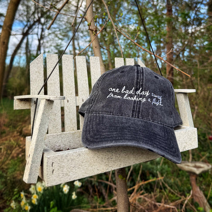"One bad day away from booking a flight" Funny hat for travel lovers - on a bird feeder