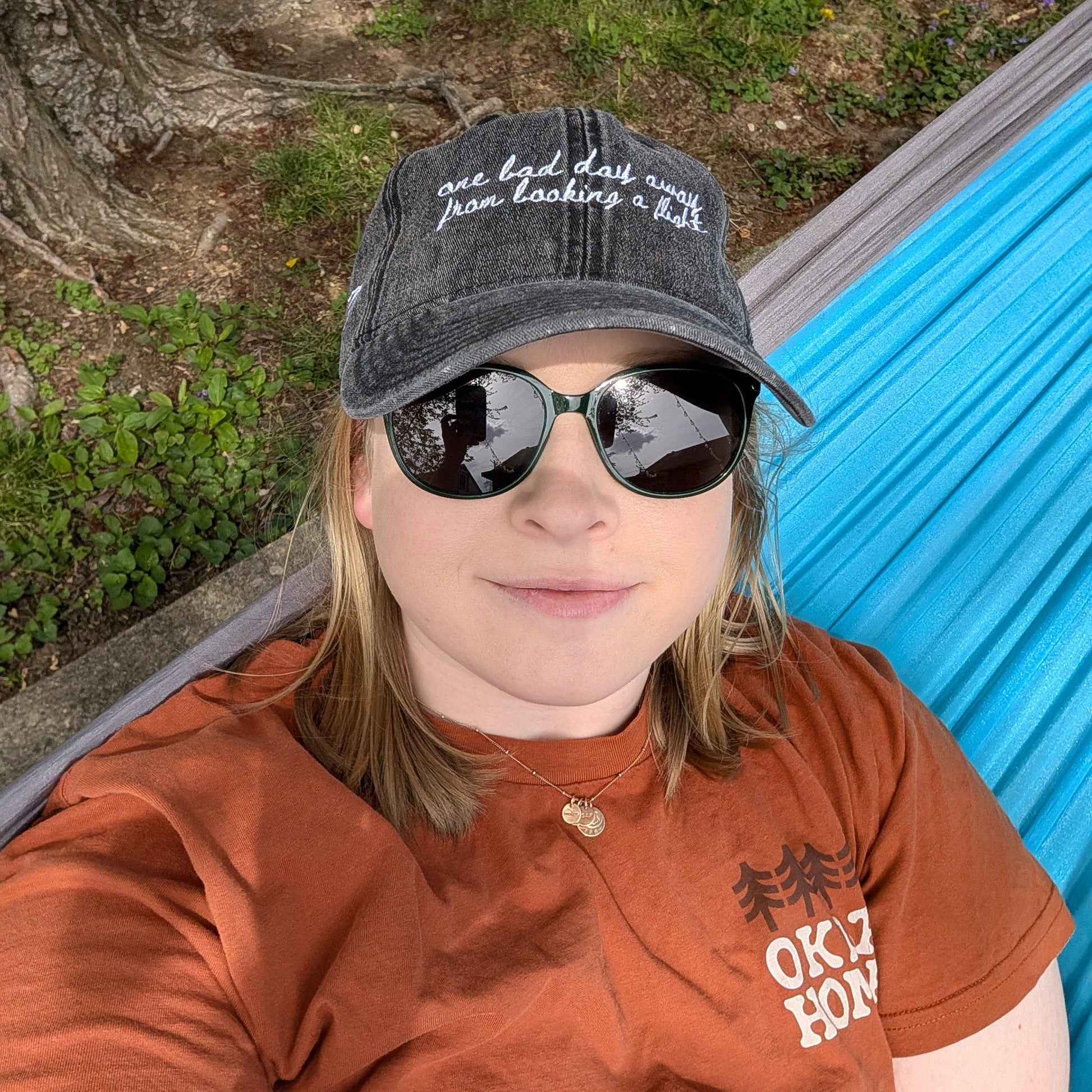 "One bad day away from booking a flight" Funny hat for travel lovers - on woman in hammock